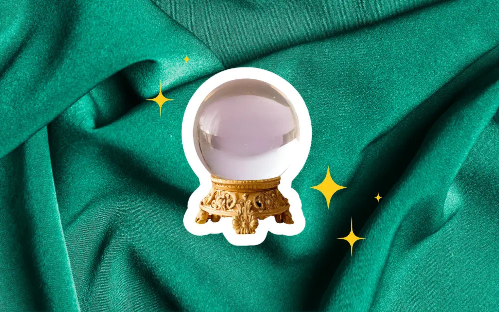 An ornate crystal ball centered on a background of textured emerald green fabric, accented with twinkling golden stars, suggesting foresight into fashion trends.