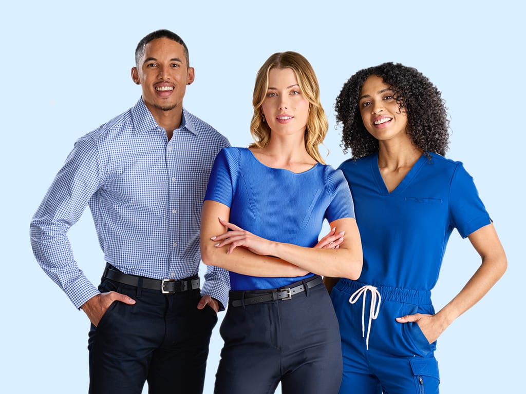 Three people dressed in medical uniforms posing in confident positions.