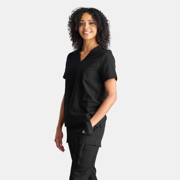 Side View of a Woman Wearing the Designs to You Midnight Black Scrubs. the Vibrant Black Colour Adds a Pop of Freshness to the Uniform, While the Comfortable Fit Ensures Ease of Movement Throughout the Day. the Image Highlights the Stylish Design and High-quality Construction of the Scrubs, Making Them a Great Choice for Healthcare Professionals.