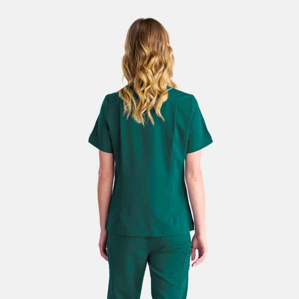 Back View of a Woman Wearing the Designs to You Fern Green Scrubs. the Sleek Green Color Adds a Touch of Elegance to the Uniform, While the Comfortable Fit Allows for Ease of Movement. the Image Showcases the Modern Design and Attention to Detail of the Scrubs, Making Them a Perfect Choice for Healthcare Professionals Seeking Both Style and Functionality.
