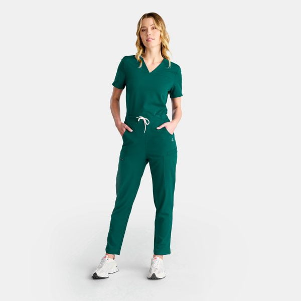 Full Body of a Women Wearing Designs to You Modern Pants in Fern Green. This Image Showcases the Stylish Design of the Pants Along with Their Numerous Pockets, Providing Both Functionality and Fashion-forward Appeal.