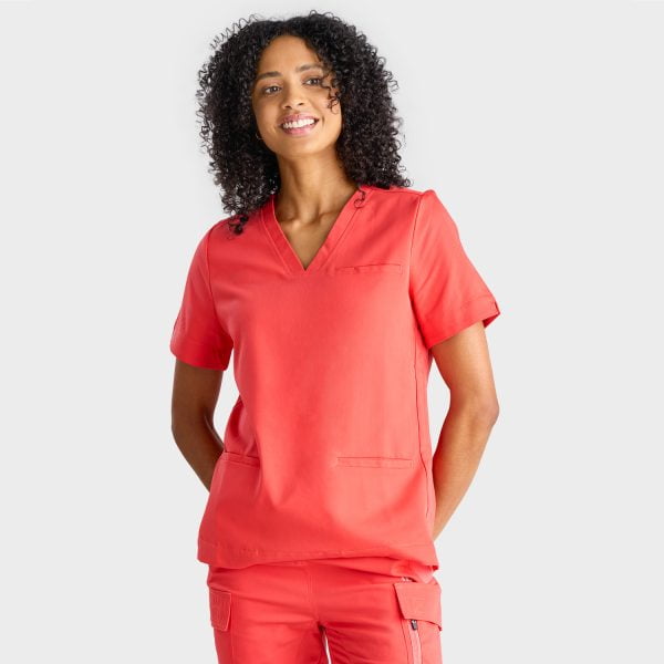 a Woman Wearing the Designs to You Watermelon Scrubs. the Vibrant Watermelon Colour Adds a Pop of Freshness to the Uniform, While the Comfortable Fit Ensures Ease of Movement Throughout the Day. the Image Highlights the Stylish Design and High-quality Construction of the Scrubs, Making Them a Great Choice for Healthcare Professionals.