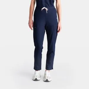 Front View of a Woman Wearing Our Best-selling Modern Twilight Navy Pants. These Straight Leg Style Pants Are Popular Among Our Customers and Feature Five Deep Pockets, Providing Convenient Storage for Nurses on the Go.