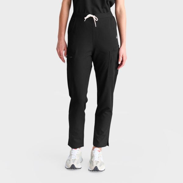View of a Woman Wearing Designs to You Midnight Black Modern Scrub Pants and Our Modern Scrub Top. the Pants Feature a Stylish Straight Leg Design and Five Deep Pockets, Combining Functionality with a Sleek Aesthetic