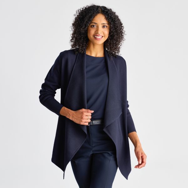 Frontal View of a Woman Smiling in a French Navy Milano Knit Waterfall Cardigan, Styled with a Coordinated Top, Trousers, and Belt.