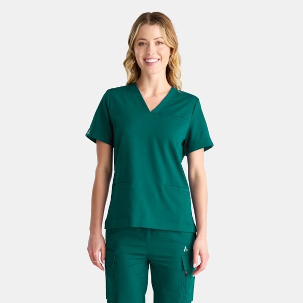 a Woman Wearing the Designs to You Fern Green Scrubs. the Sleek Green Colour Adds a Touch of Elegance to the Uniform, While the Comfortable Fit Allows for Ease of Movement. the Image Showcases the Modern Design and Attention to Detail of the Scrubs, Making Them a Perfect Choice for Healthcare Professionals Seeking Both Style and Functionality.