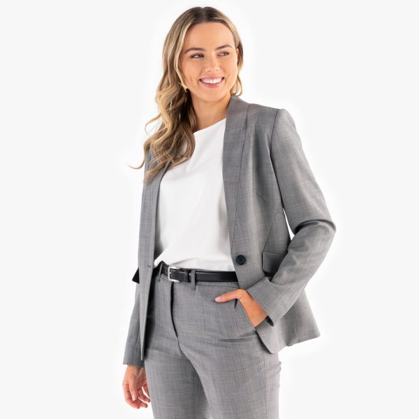 a Smiling Woman Posing in a Stylish Grey Check Blazer over a White Top and Matching Check Pants, Complemented by a Sleek Black Belt.