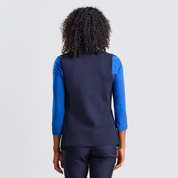 Back View of a Women's Milano Knit Waterfall Vest in French Navy, Showing the Garment's Smooth Back and Graceful Lines, Layered over a Blue Top for a Pop of Color.