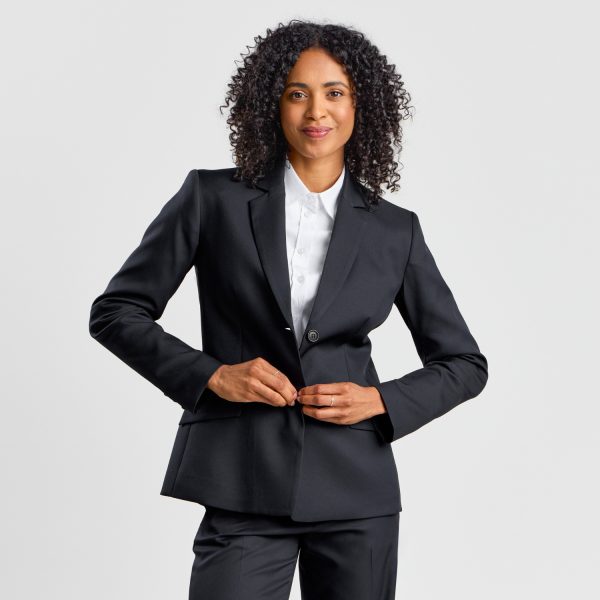 Woman Buttoning a Black Classic 2-button Blazer, Giving a Confident Look Towards the Camera.
