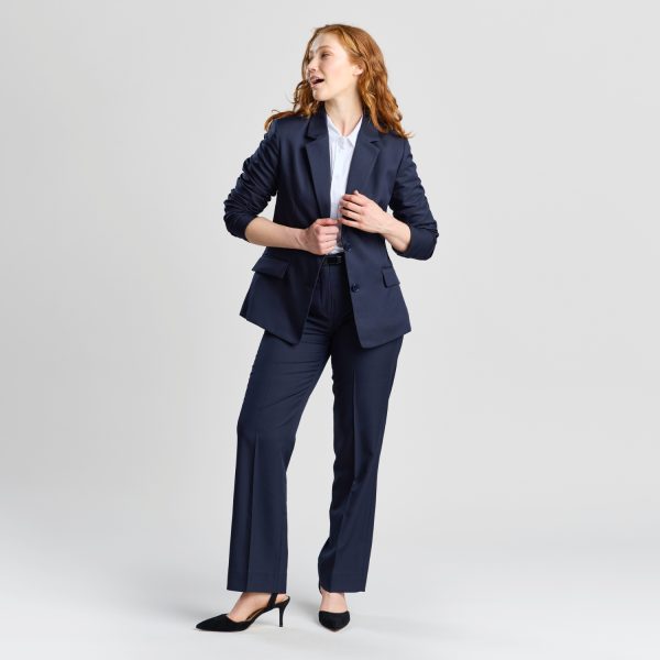 Full-length Shot of a Woman in a French Navy Classic 2-button Blazer Paired with Matching Trousers and Black Heels, Looking to the Side.