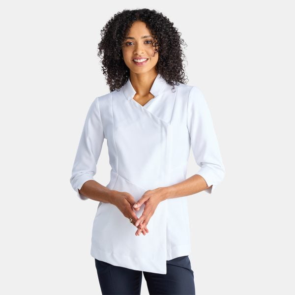Front View of a Woman Wearing a White Asymmetric Pharmacy Jacket with 3/4 Sleeves, Paired with Navy Pants.