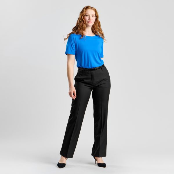 Full View of a Smiling Model in Relaxed Leg Pant in Black, Complemented with a Vibrant Blue Blouse and Classic Black Heels, Embodying a Smart Casual Style.