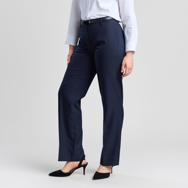 a Confident Professional Look in the Relaxed Leg Pant in French Navy, Shown from a Side View. the Design Emphasizes Comfort Without Sacrificing Style, Paired with a Crisp White Shirt and Sleek Black Heels.