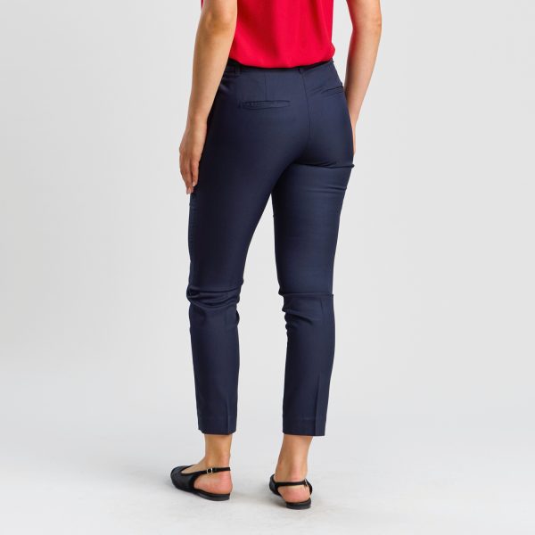 Rear View of Women's Slim Style Chino Pant in French Navy, Showcasing a Streamlined Silhouette and Elegant Back Pocket Stitching, Paired with Flat Black Shoes.