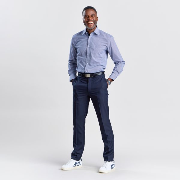 Full-length Image of a Man in a Men's Slim Fit Long Sleeve Shirt in Navy Mini Check and Navy Trousers, Completed with White Sneakers for a Modern, Smart Casual Appearance.