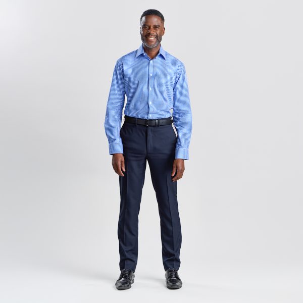 Full Body Shot of a Man Standing, Dressed in a Blue Checkered Long Sleeve Shirt and Navy Trousers.