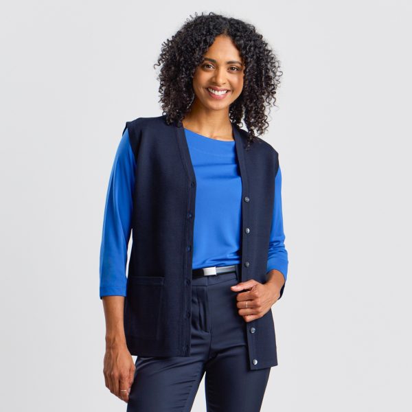 Front Angle of a Women's Milano Knit Button Front Vest in French Navy, Showing the Sharp Lapel Design and Button Detail, Worn over a Bright Blue Boat Neck Top.