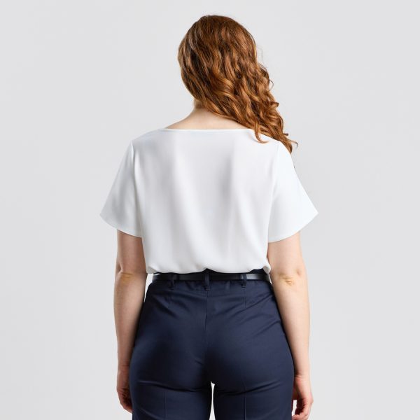 Rear View of an Ivory Bell Sleeve Blouse, Detailing the Flow of the Sleeves and Fit Along the Waist.