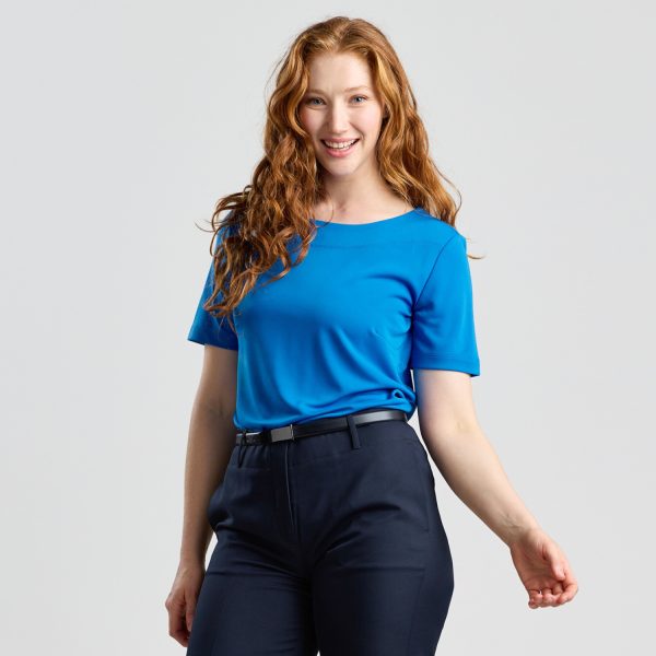 a Side View of a Model Wearing a Marine Soft Knit Boat Neck Top, with Navy Trousers and a Relaxed Pose.
