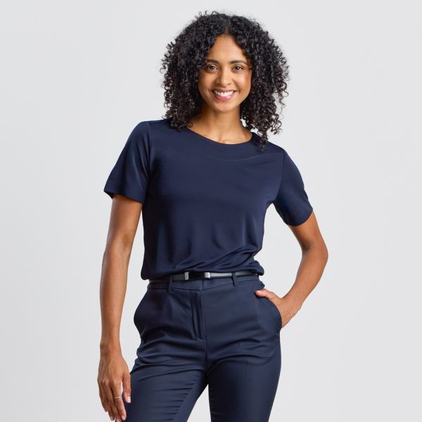 Frontal View of a Model Smiling in a Navy Soft Knit Boat Neck Top, Paired with Navy Trousers.