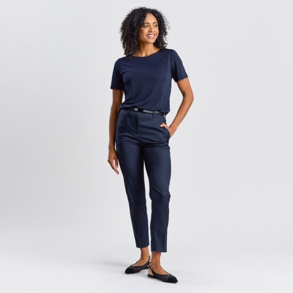 Full Body View of a Model in a Navy Soft Knit Boat Neck Top, Complete with Navy Trousers and Black Flats.