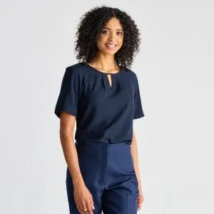 Model Facing Forward, Wearing a Navy Keyhole Blouse with Short Sleeves, Giving a Friendly Smile.