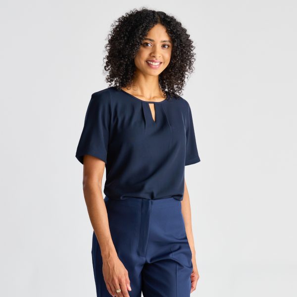Model Facing Forward, Wearing a Navy Keyhole Blouse with Short Sleeves, Giving a Friendly Smile.