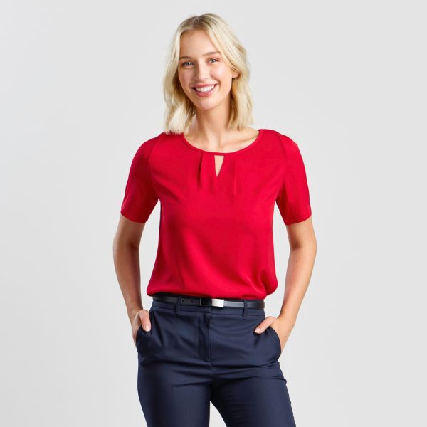 a Model with a Smile, Dressed in a Ruby Keyhole Blouse with Short Sleeves, Complementing Navy Trousers.