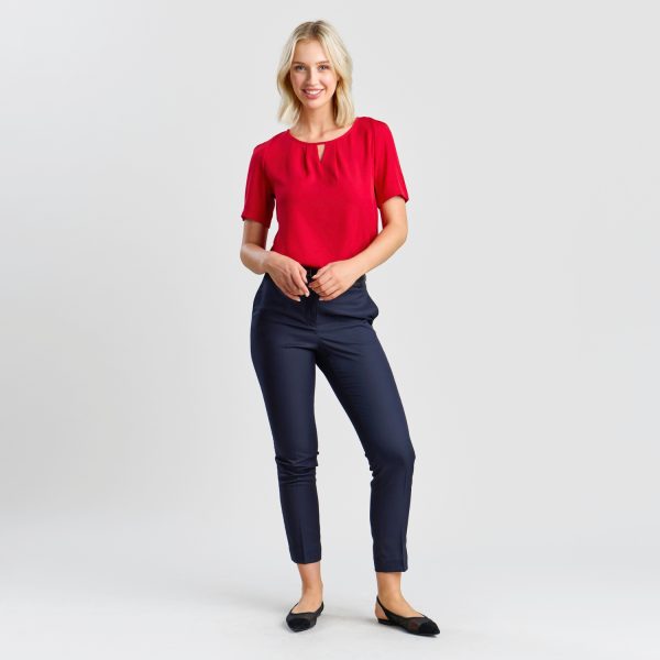Full Stance of a Model in a Vibrant Ruby Keyhole Blouse and Navy Ankle-length Trousers, Hands Poised Casually.