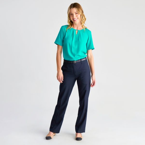 Full-length View of a Model Wearing a Teal Keyhole Blouse and Navy Trousers, with a Hand on Her Hip.