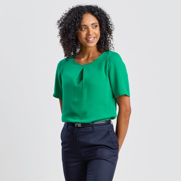 Frontal View of a Model Wearing an Emerald Green Blouse with a Distinctive Pleat, Matched with Navy Trousers.