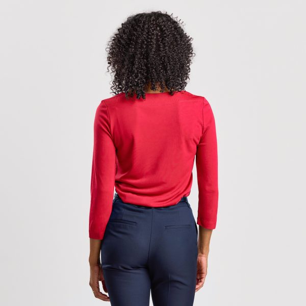 Rear View of a Woman in a Ruby Soft Knit Boat Neck Top with Three-quarter Sleeves, Paired with Navy Trousers.
