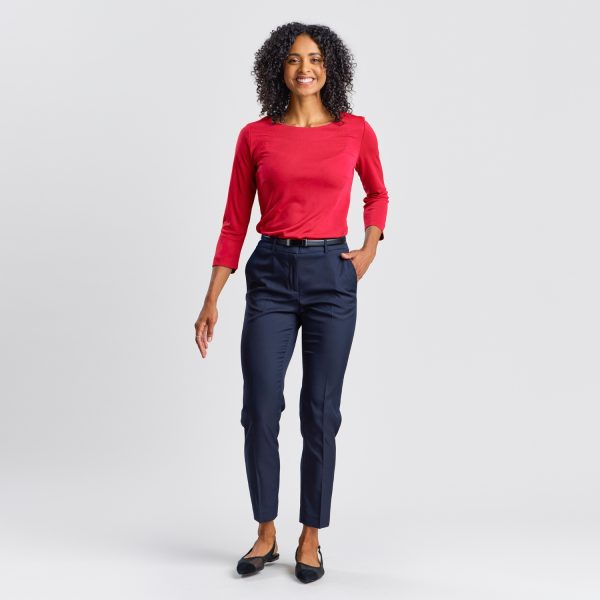 Full-length Image of a Smiling Woman in a Ruby Soft Knit Boat Neck Top, Paired with Navy Trousers and Black Flats.