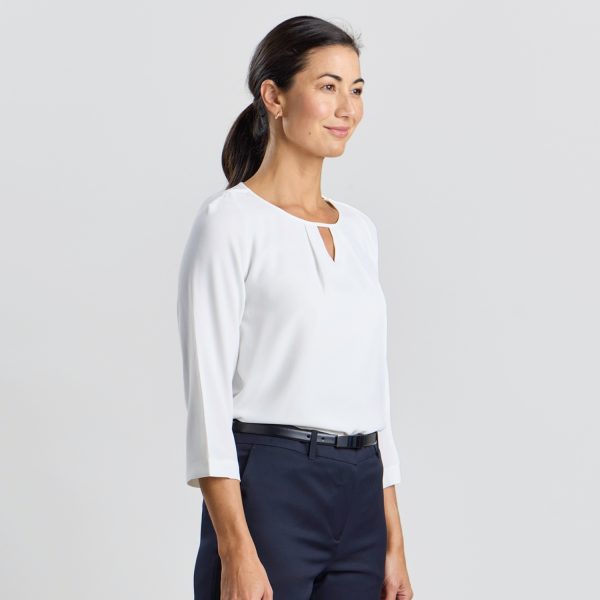 Side Profile of a Model in an Ivory Blouse with Keyhole Detail and 3/4 Sleeves.