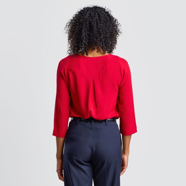 Back View of a Ruby Keyhole Blouse with 3/4 Sleeves, Highlighting the Pleat Detail and Fit.