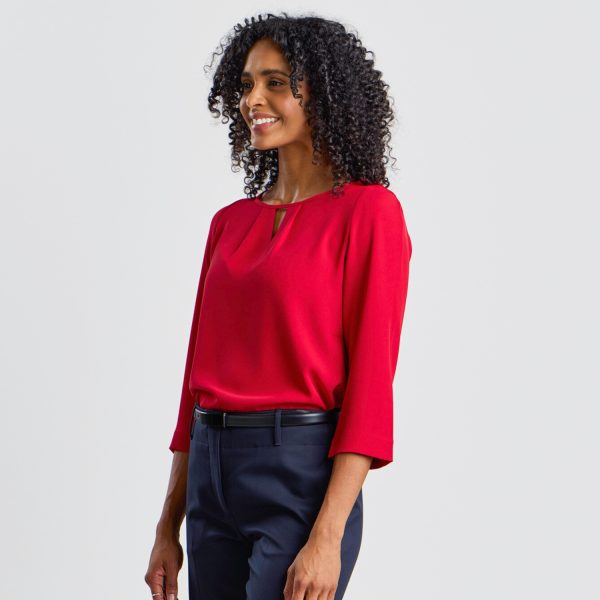 Side Angle of a Model in a Ruby Keyhole Blouse with 3/4 Sleeves, Emphasizing the Blouse’s Shape.