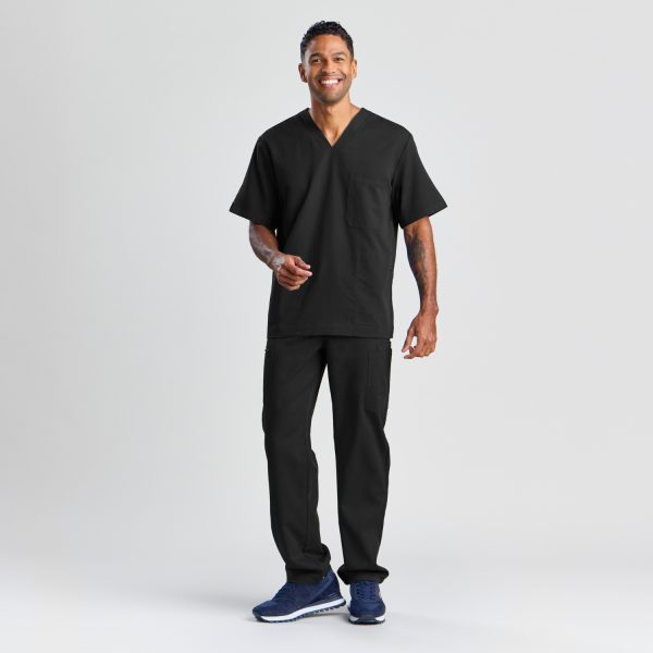 Full-body Image of a Man Modeling the Men's Modern Scrub Top in Black, Complete with Matching Pants and Stylish Sneakers, Highlighting a Smart, Casual Look.