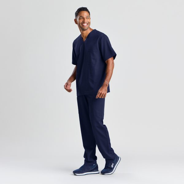 Full-length Front View of a Man in the Men's Modern Scrub Top in Navy, Providing a Clear Look at the Top's Fit and Styling.