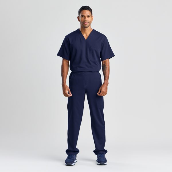 Full Body Portrait of a Male Model in Men's Modern Scrub Pant in Twilight Navy with a Matching Top, Exuding Comfort and Practicality for Medical Settings.
