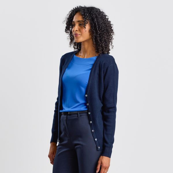 Angled View of a Woman Wearing a French Navy Warm Knit Button Front Cardigan, with a Blue Top Beneath, Looking off to the Side.