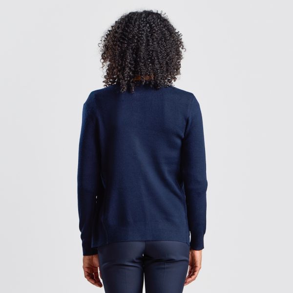 Back View of a French Navy Warm Knit Button Front Cardigan on a Woman with Curly Hair, Showing the Cardigan's Length and Fit.
