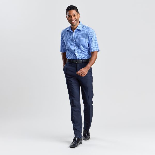 Full Body View of a Man Smiling and Posing in French Navy Regular Fit Business Pants, a Blue Checked Shirt, and Black Leather Shoes, Set Against a White Backdrop.