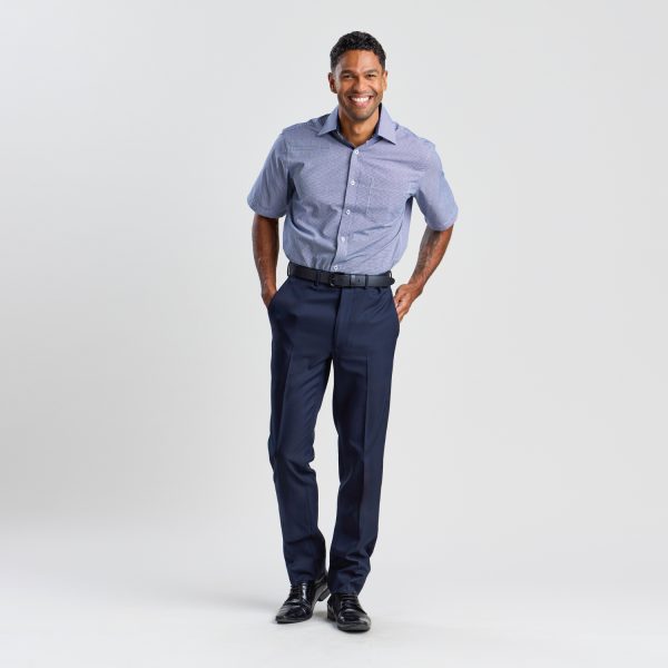Full Body View of a Smiling Person Confidently Standing in French Navy Slim Fit Business Pants, a Tucked-in Blue Shirt, and Black Shoes, on a White Background.