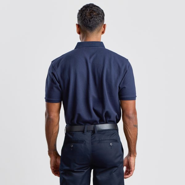 Rear View of a Man in a Navy Men's Cotton Polo, Highlighting the Polo's Clean Lines and Relaxed Shoulders for a Versatile Workwear Option.