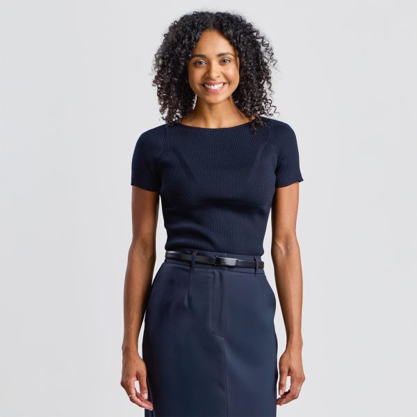 Woman Wearing a Fitted Navy Top, Navy Work Pencil Skirt, and a Slim Black Leather Belt.