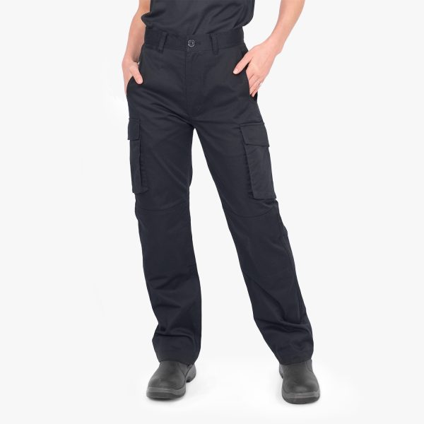 a Woman Wearing Designs to You Unisex Chino Cargo Pants in French Navy. She Has Her Hands in the Pockets and Stands Confidently, Showing the Great Design and Quality of the Pants.