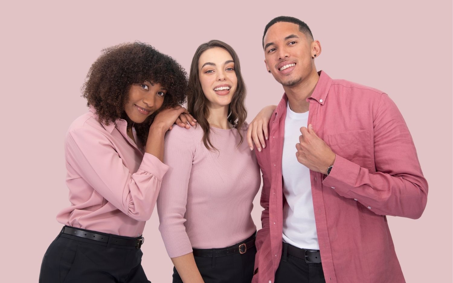 The banner for the article 'Why Investing in a Quality Uniform' depicts three young, professional looking models wearing stylish, high-quality pink uniforms manufactured by Designs To You. They're smiling confidently at the camera and standing in front of a light pink background.