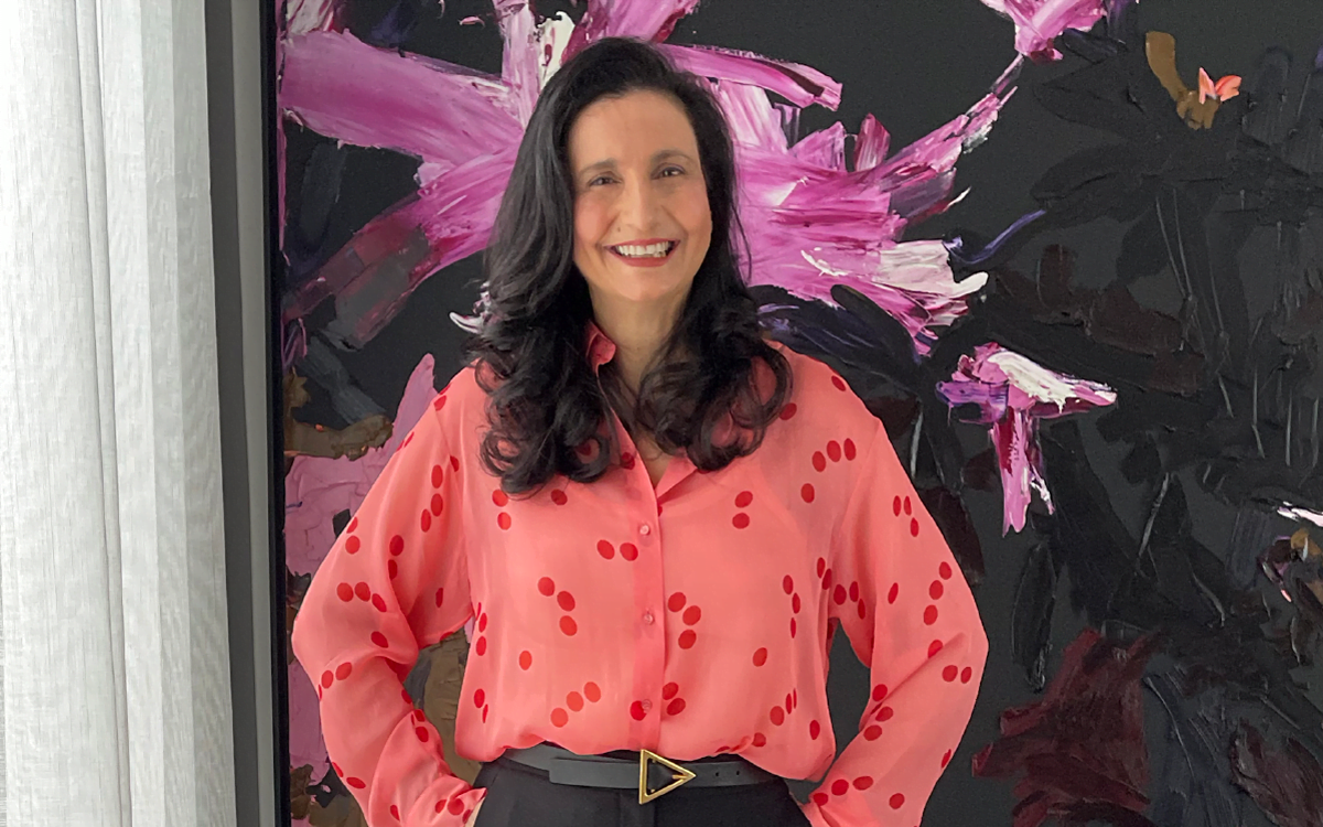 The banner for the article 'Meet 'The Uniform Lady'' features an image of Designs To You's CEO and Creative Director, Maria Grossi smiling confidently at the camera. The image taken as part of Maria's feature in ANZ Bank's Women in Leadership series.