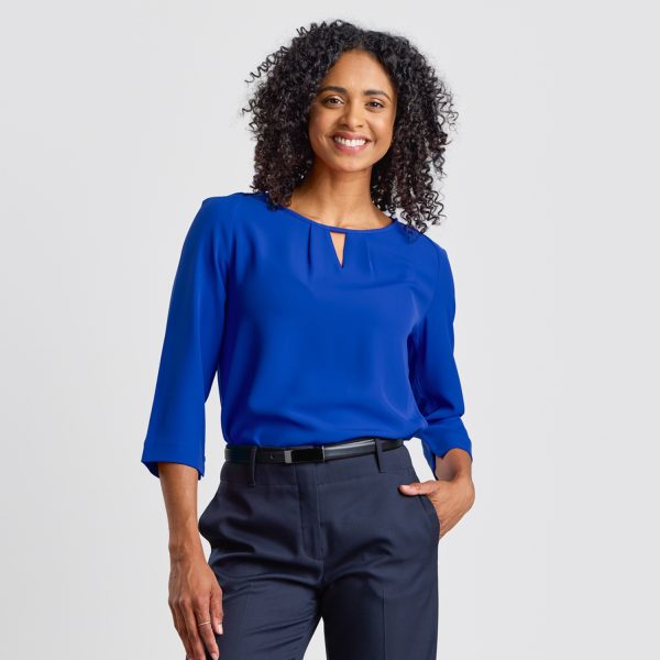 Front View of a Woman Smiling in a Royal Blue Keyhole Blouse with a Subtle Keyhole Neckline Detail.