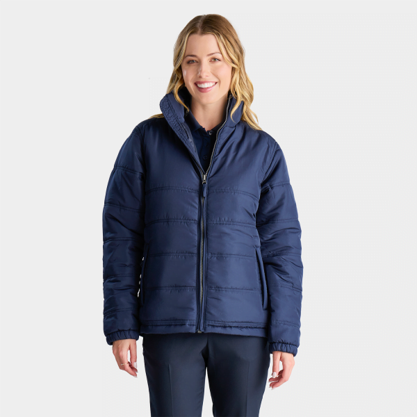a Woman in a Navy Blue Winter Puffer Jacket with a Zip-up Front and a Collared Neckline, Teamed with Coordinating Navy Trousers, Suitable for Outdoor Staff Uniforms in Cooler Climates.